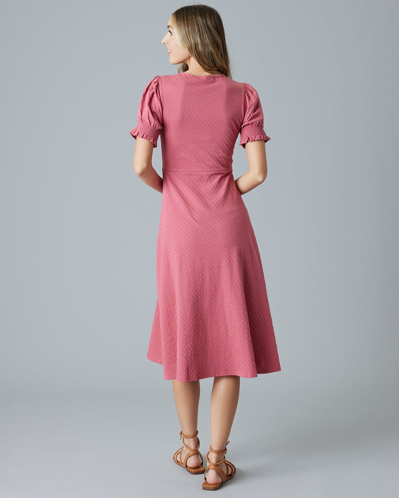 Woman in a pink short sleeve, midi-dress