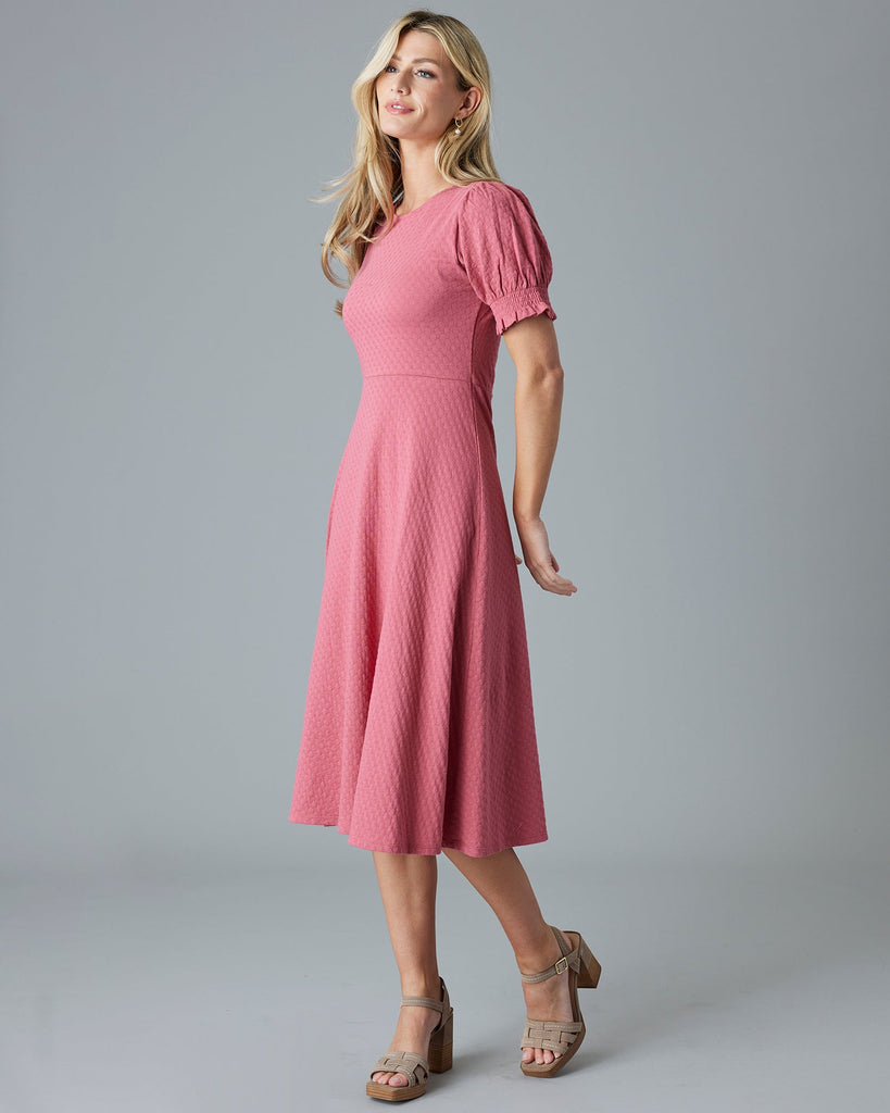 Woman in a pink short sleeve, midi-dress