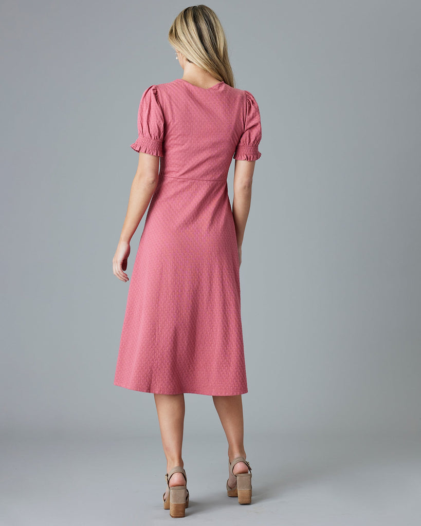 Woman in a pink short sleeve, midi-dress