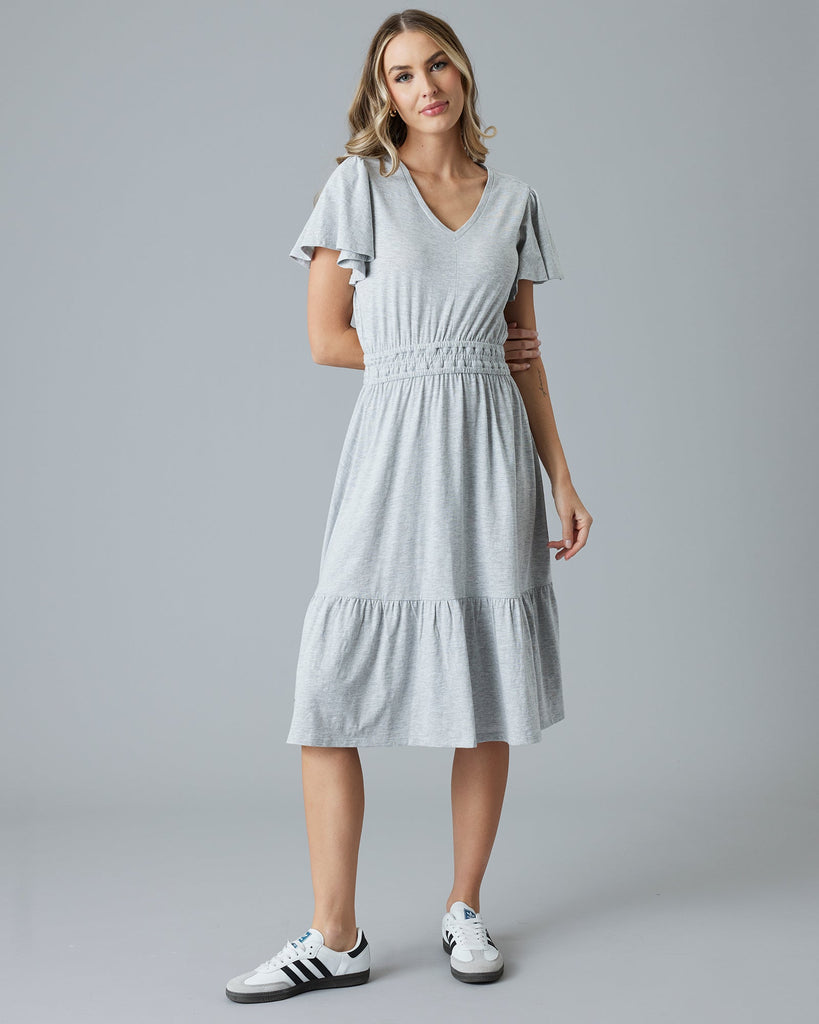 Woman in a grey short sleeve midi dress