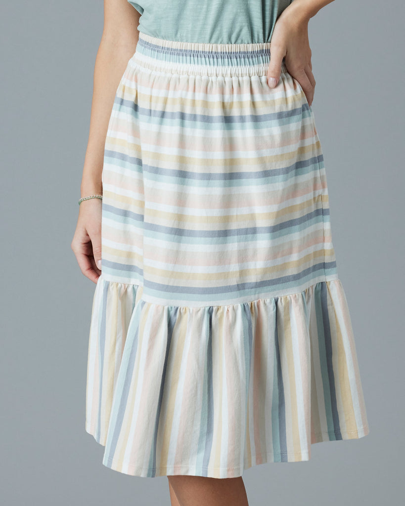 Woman in a pastel rainbow knee-length skirt