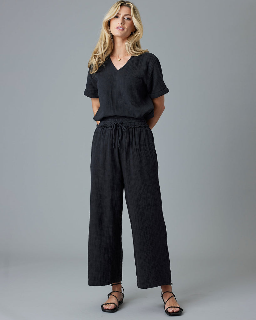 Woman in black ankle-length pants