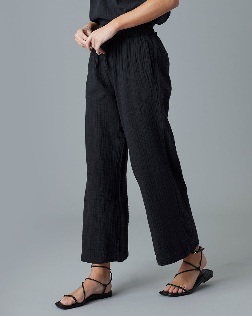 Woman in black ankle-length pants