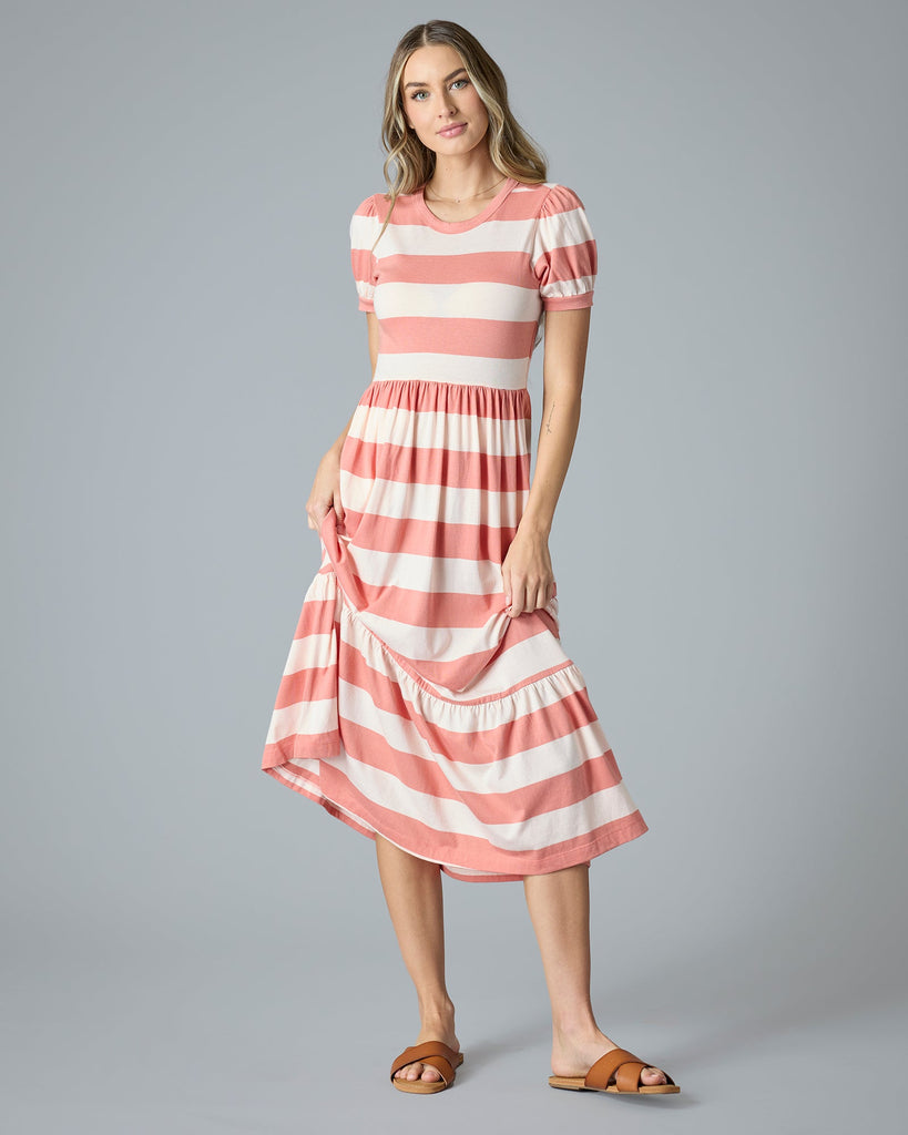 Woman in a pink and white striped a-line t-shirt dress