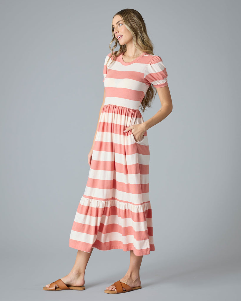 Woman in a pink and white striped a-line t-shirt dress