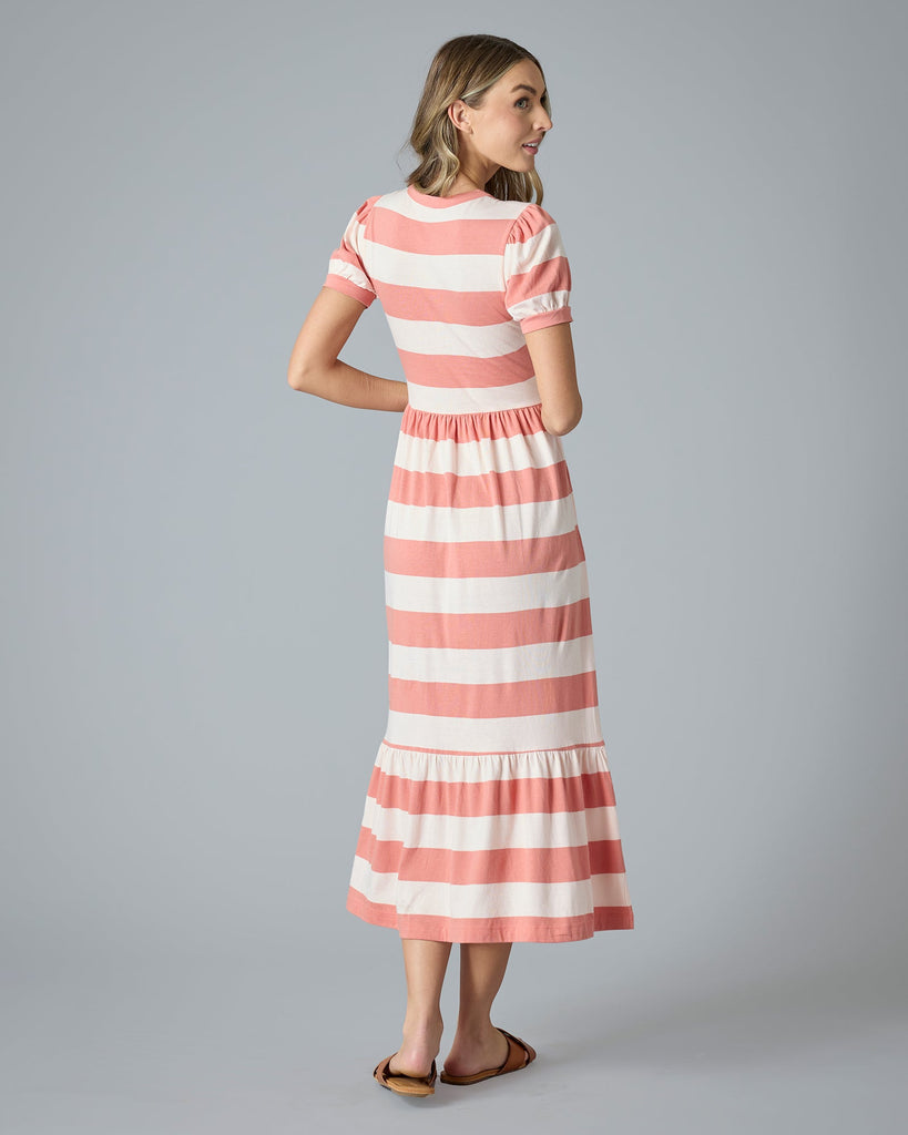 Woman in a pink and white striped a-line t-shirt dress