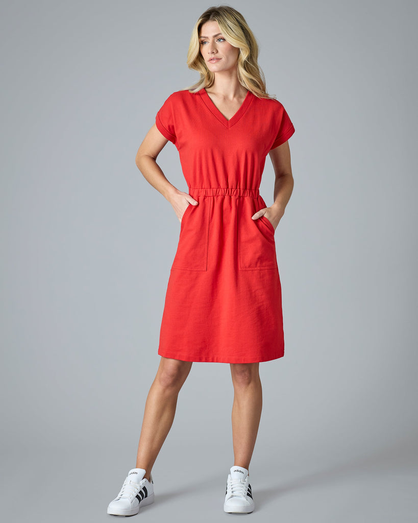 Woman in red short sleeve, knee-length dress with pockets