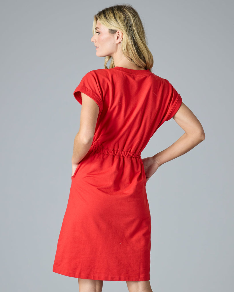 Woman in red short sleeve, knee-length dress with pockets