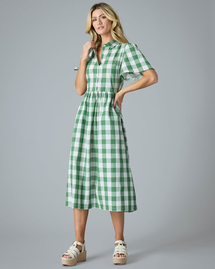 Woman in a plaid green short sleeve midi-length dress