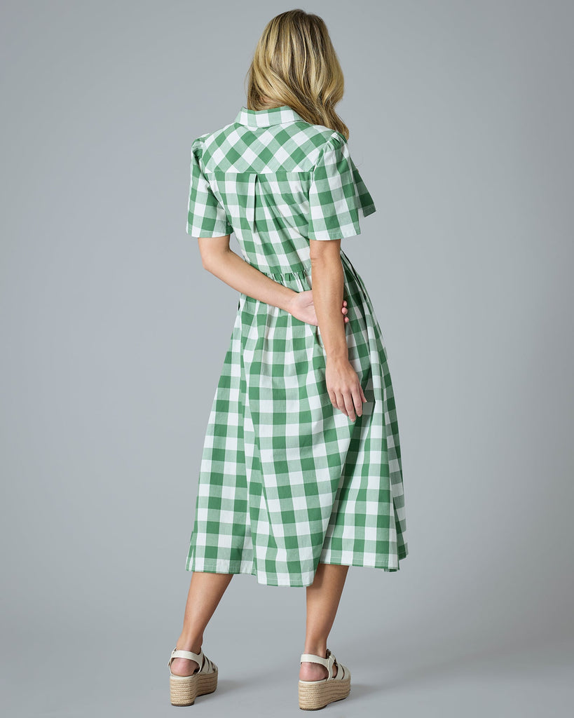 Woman in a plaid green short sleeve midi-length dress