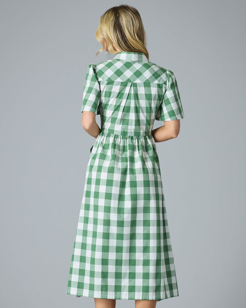 Woman in a plaid green short sleeve midi-length dress