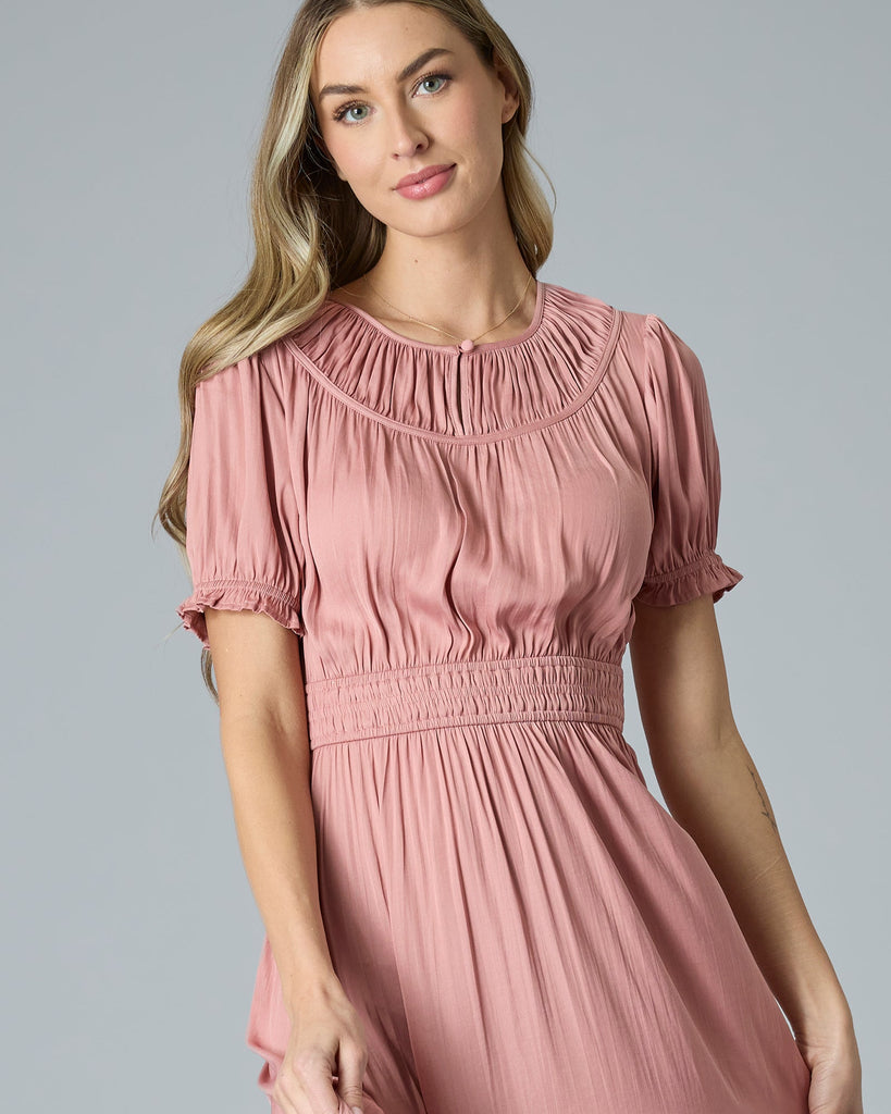 Woman in a pink short sleeve maxi dress