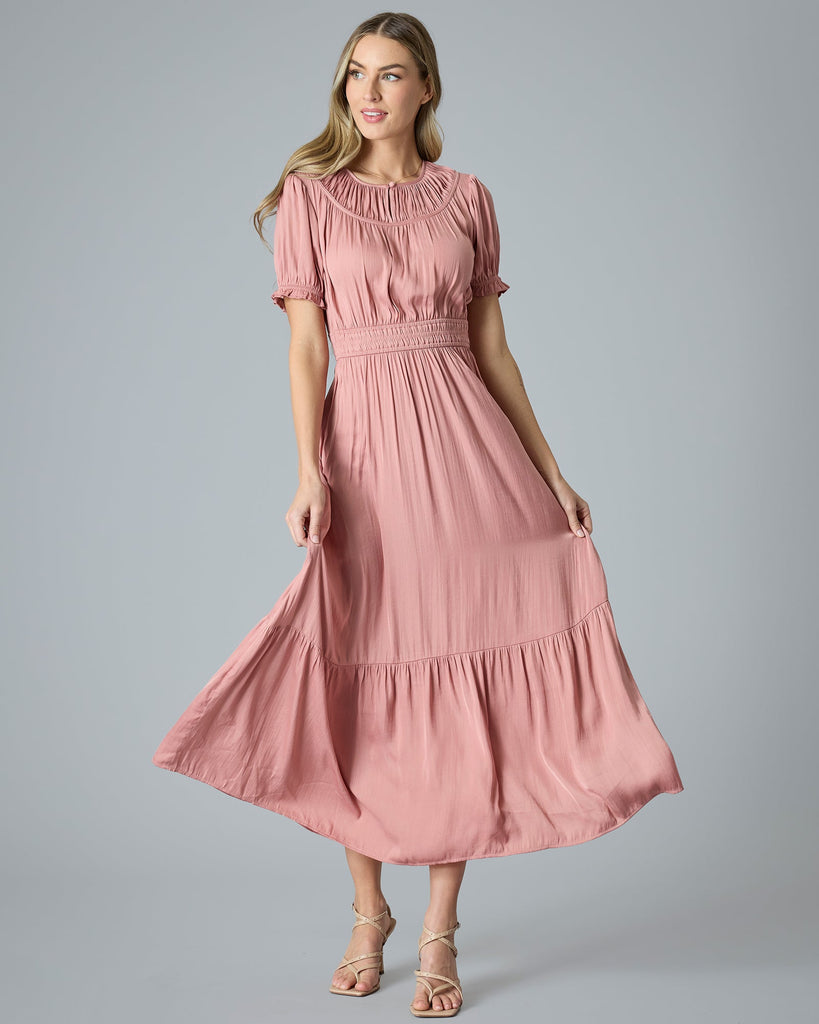 Woman in a pink short sleeve maxi dress