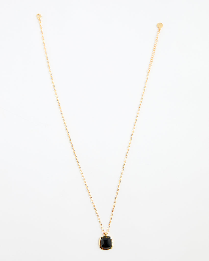 Gold chain necklace with black gem pendant