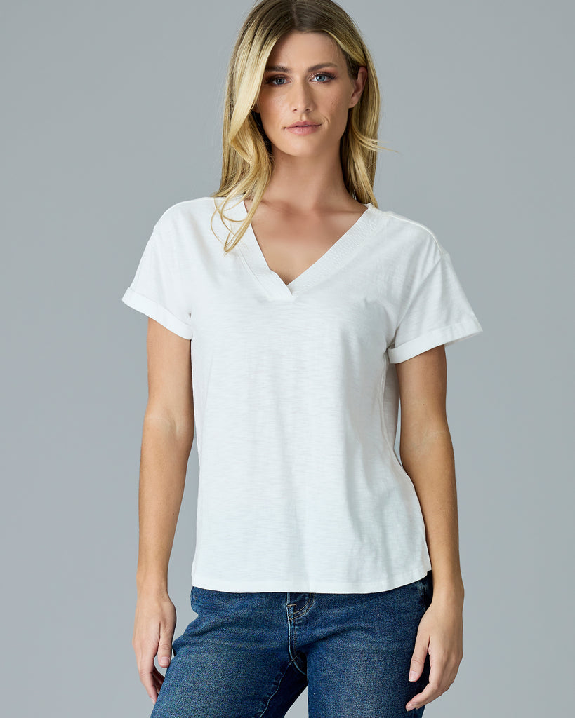 Woman in a white, short sleeve v-neck tee