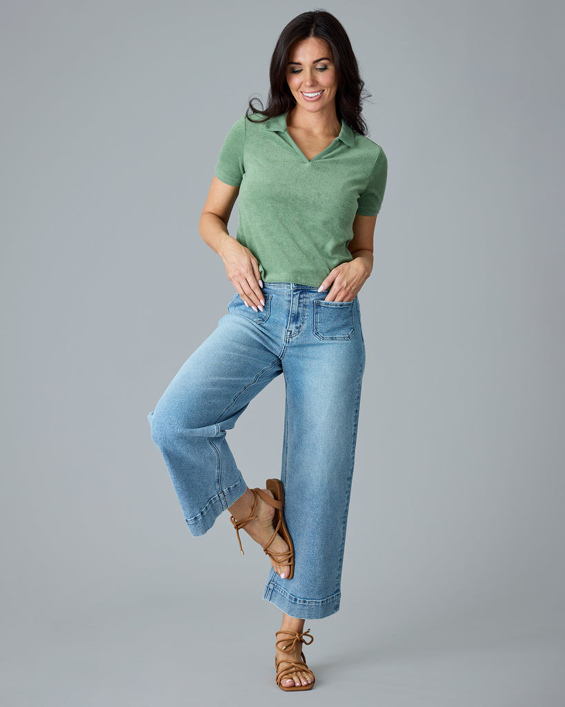 Woman in a green, short sleeve, collared terry cloth top