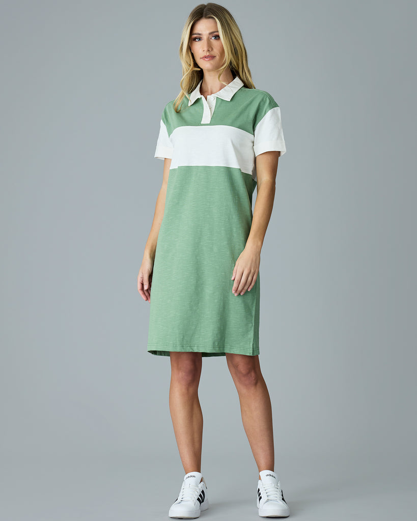 Woman in a green, short sleeve dress with collar