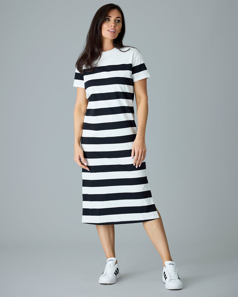 Woman in a black and white striped, short sleeve, sheath dress