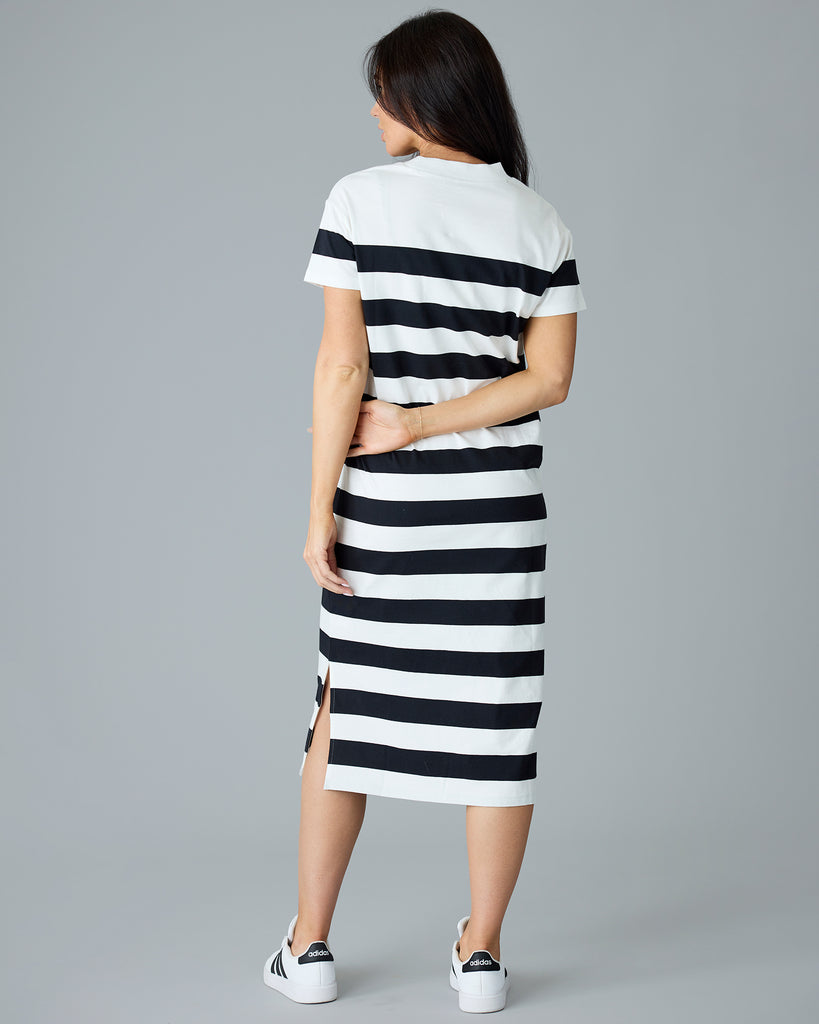 Woman in a black and white striped, short sleeve, sheath dress