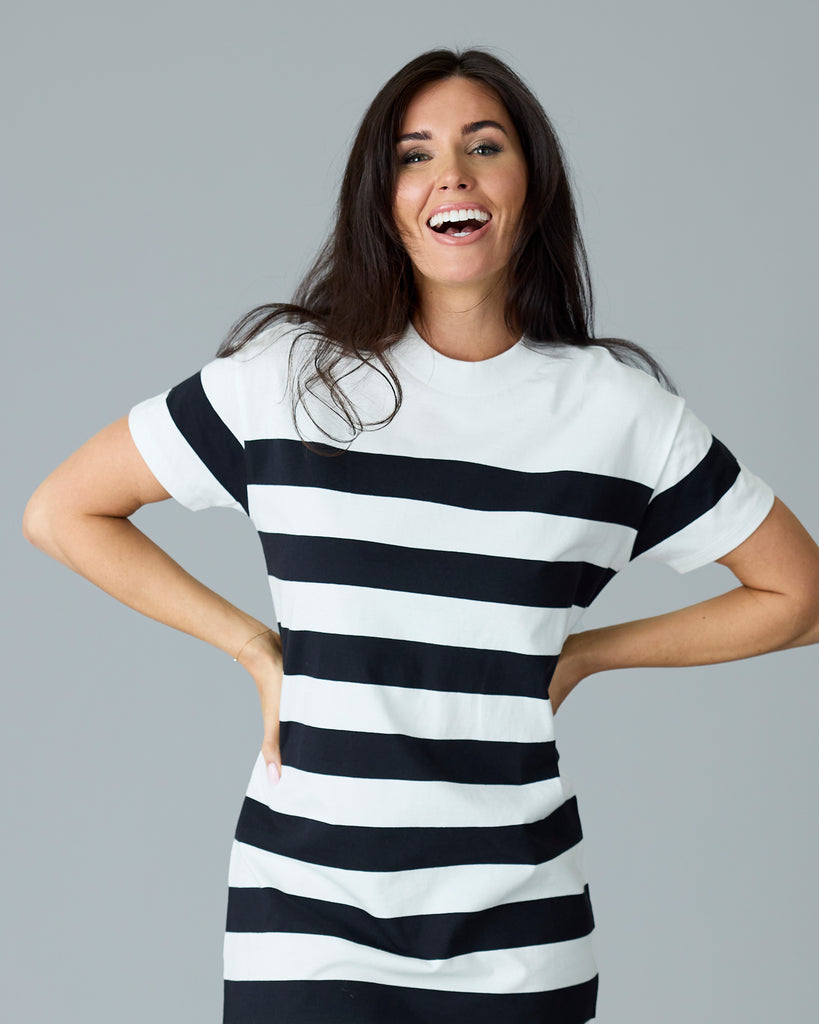 Woman in a black and white striped, short sleeve, sheath dress