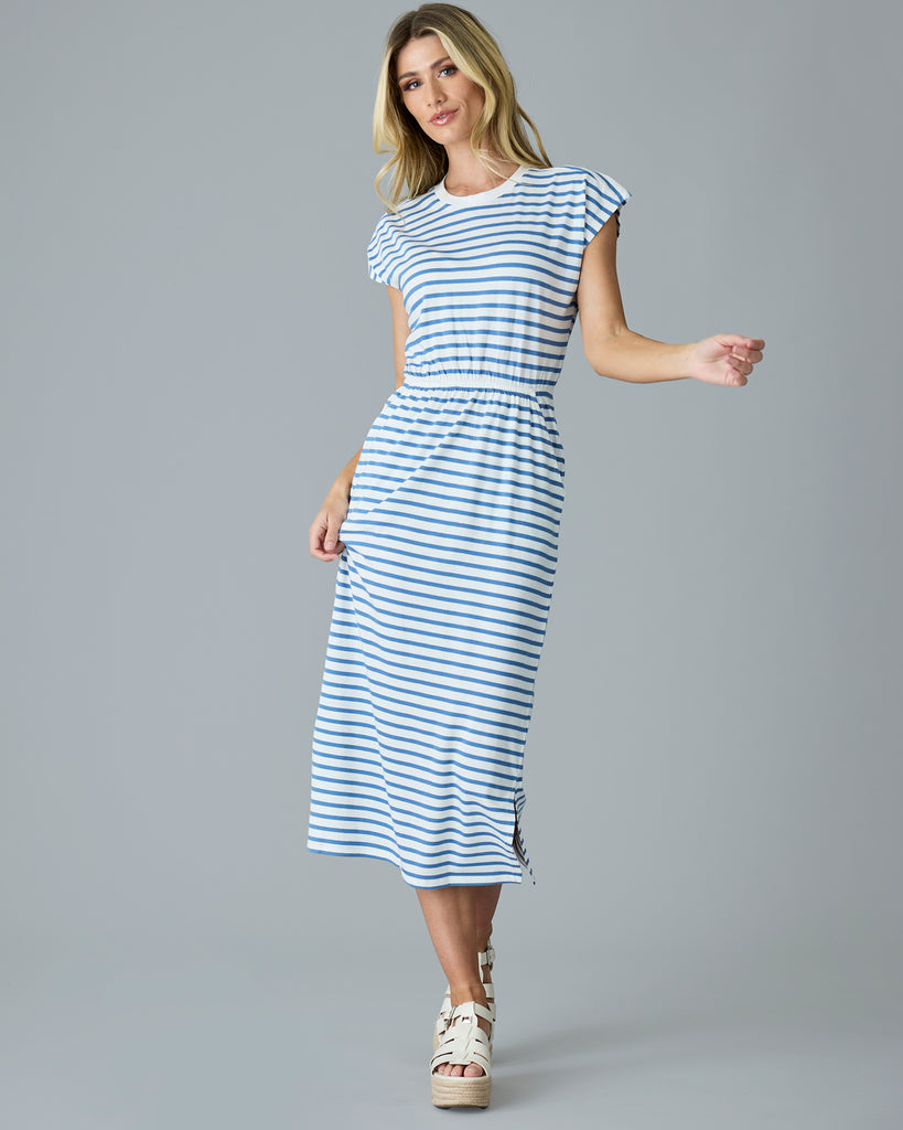 Woman in a blue and white striped, short sleeve, midi dress