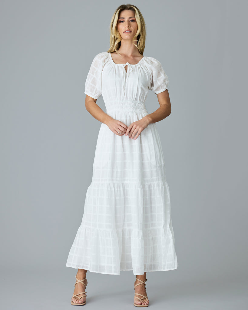 Woman in a white, short sleeve, maxi dress