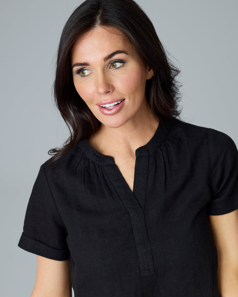 Woman in a black short sleeve blouse