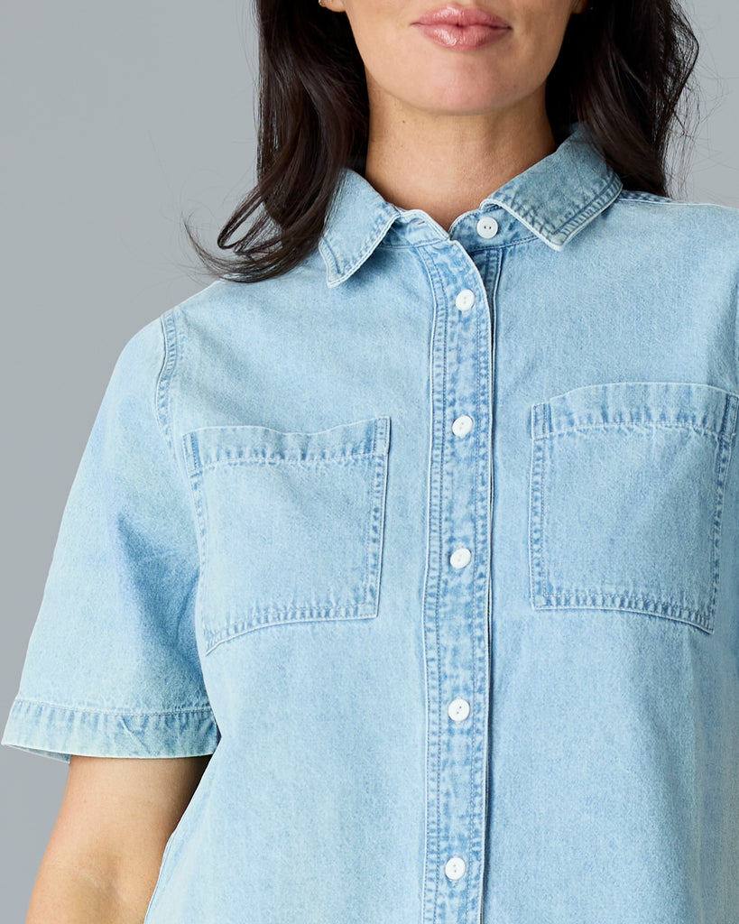 Woman in a light blue chambray short sleeve buttondown