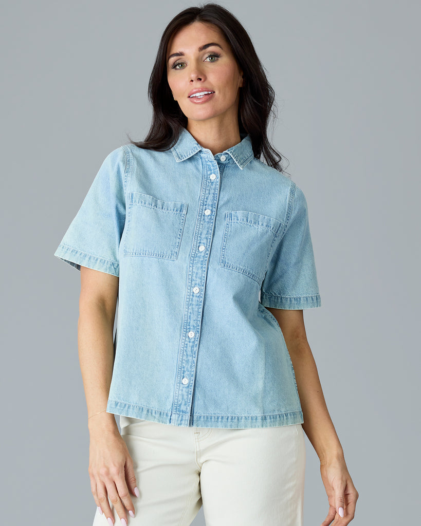 Woman in a light blue chambray short sleeve buttondown