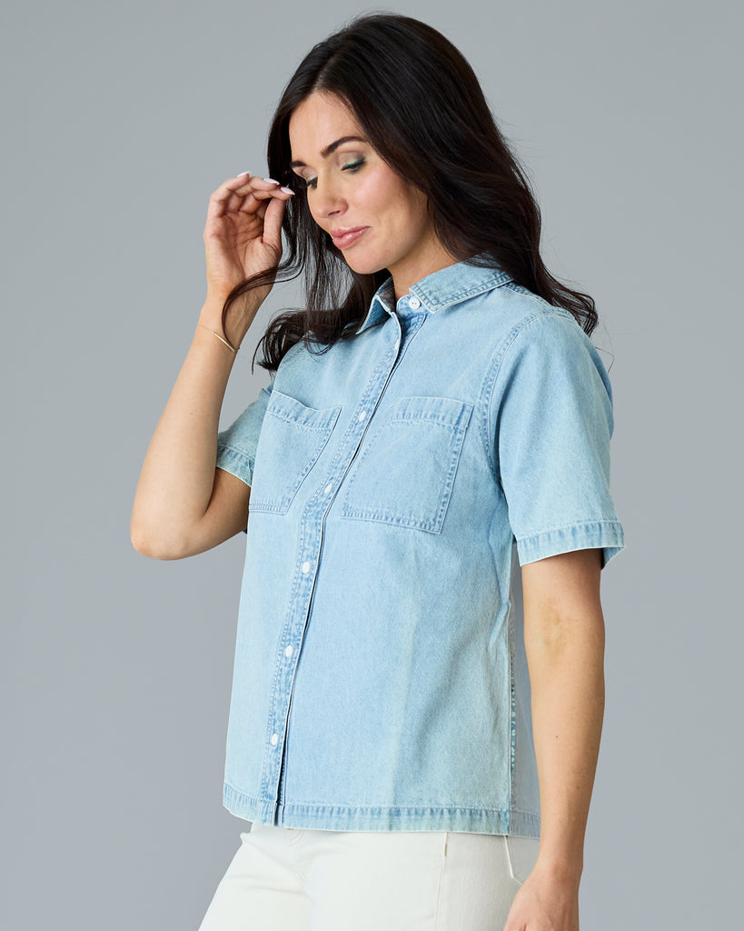 Woman in a light blue chambray short sleeve buttondown