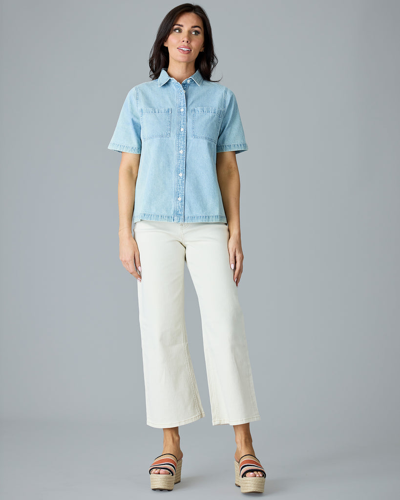 Woman in a light blue chambray short sleeve buttondown