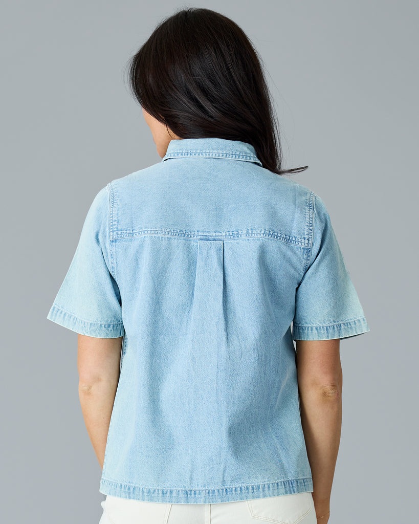 Woman in a light blue chambray short sleeve buttondown