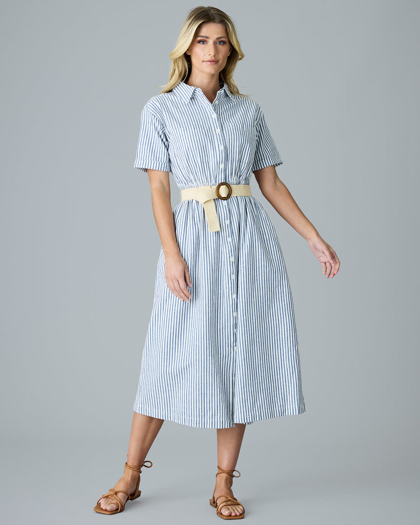 Woman in a blue and white vertical stripe, short sleeve linen dress