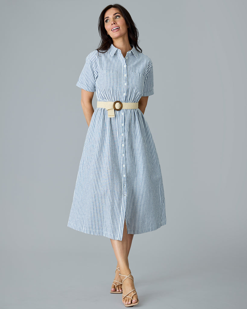 Woman in a blue and white vertical stripe, short sleeve linen dress