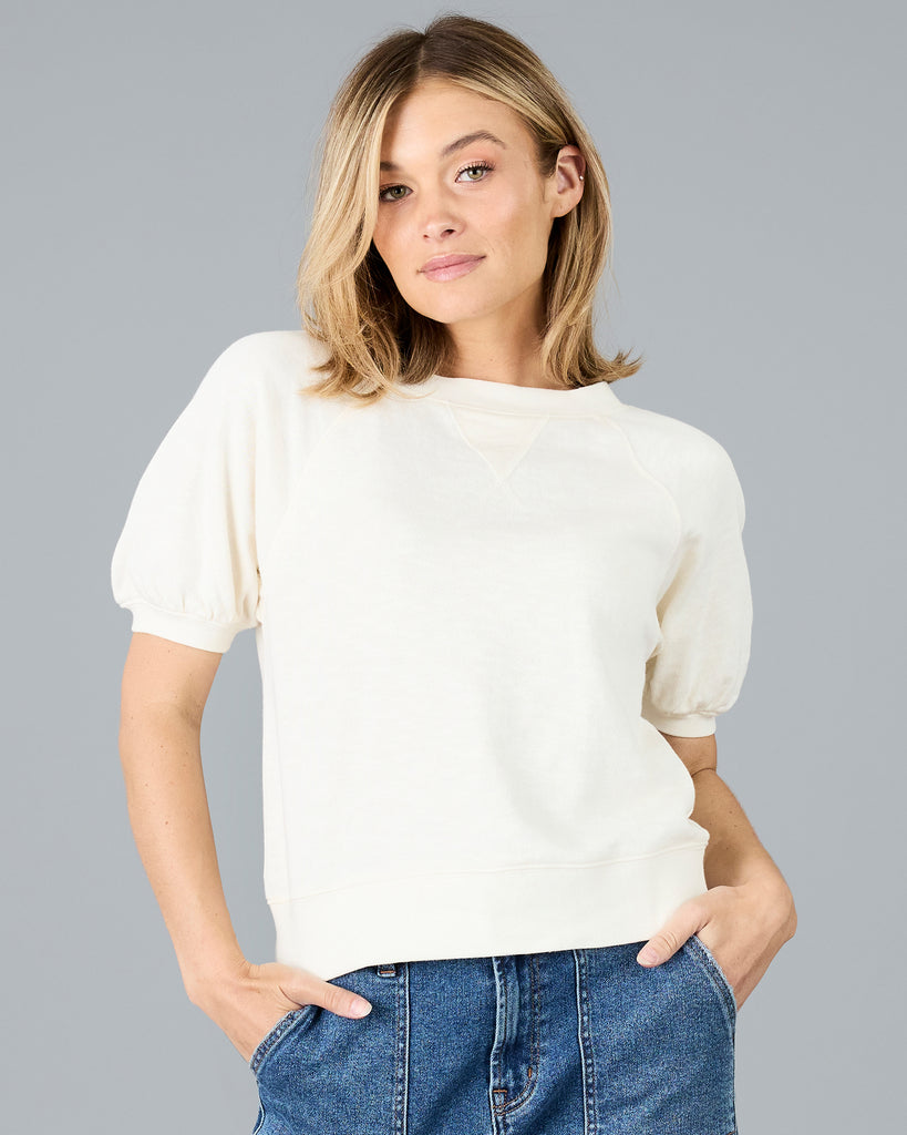 Woman in a short sleeve white sweater