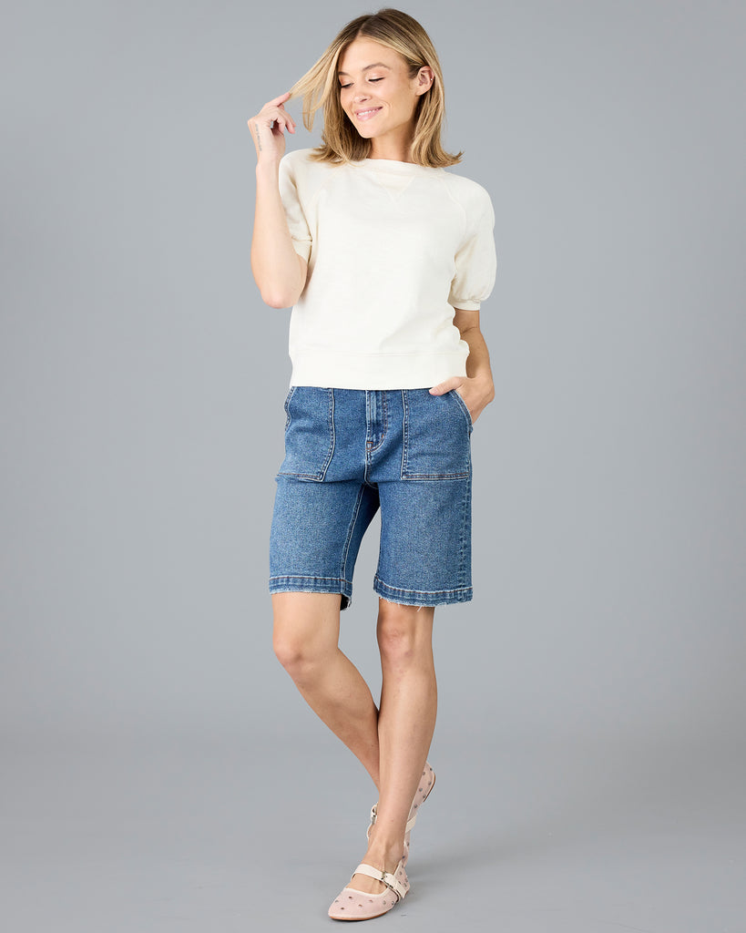 Woman in a short sleeve white sweater