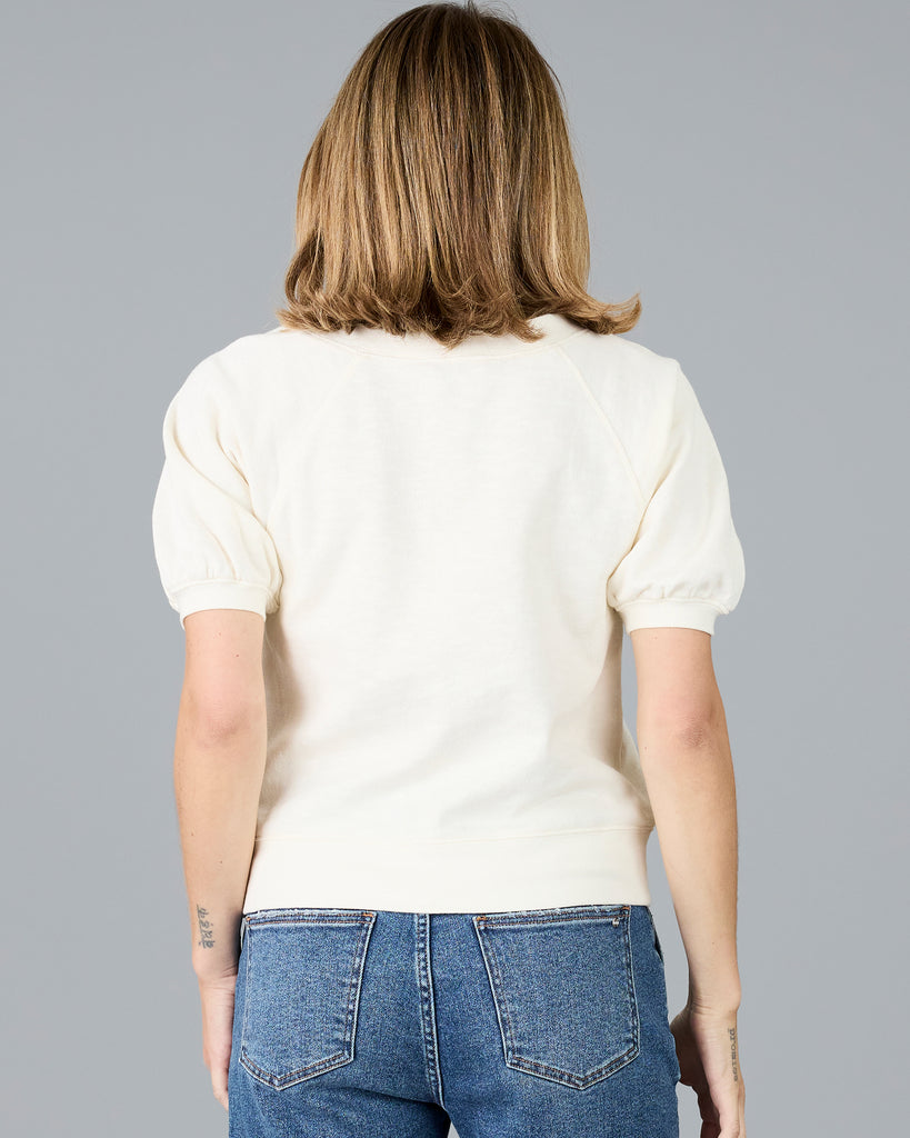 Woman in a short sleeve white sweater