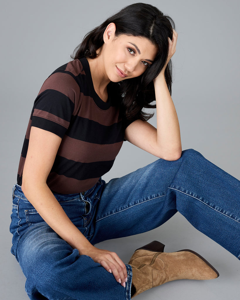 Woman in a short sleeve brown and black striped t-shirt