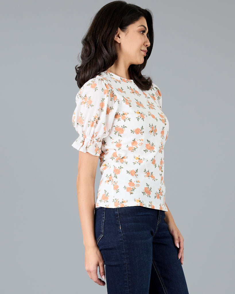 Woman in a short sleeve floral print top