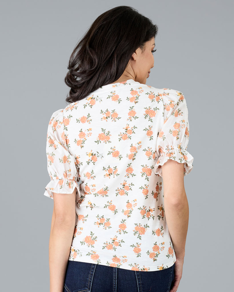 Woman in a short sleeve floral print top