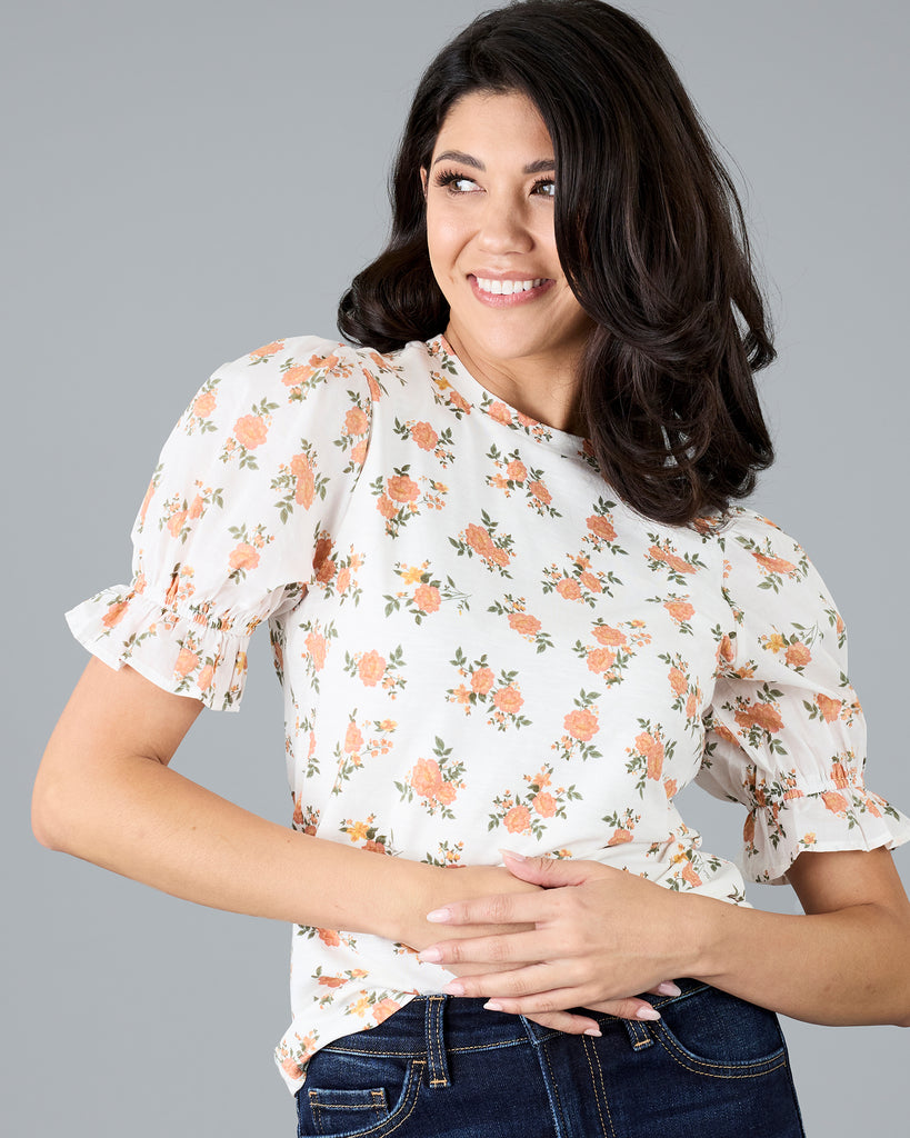 Woman in a short sleeve floral print top