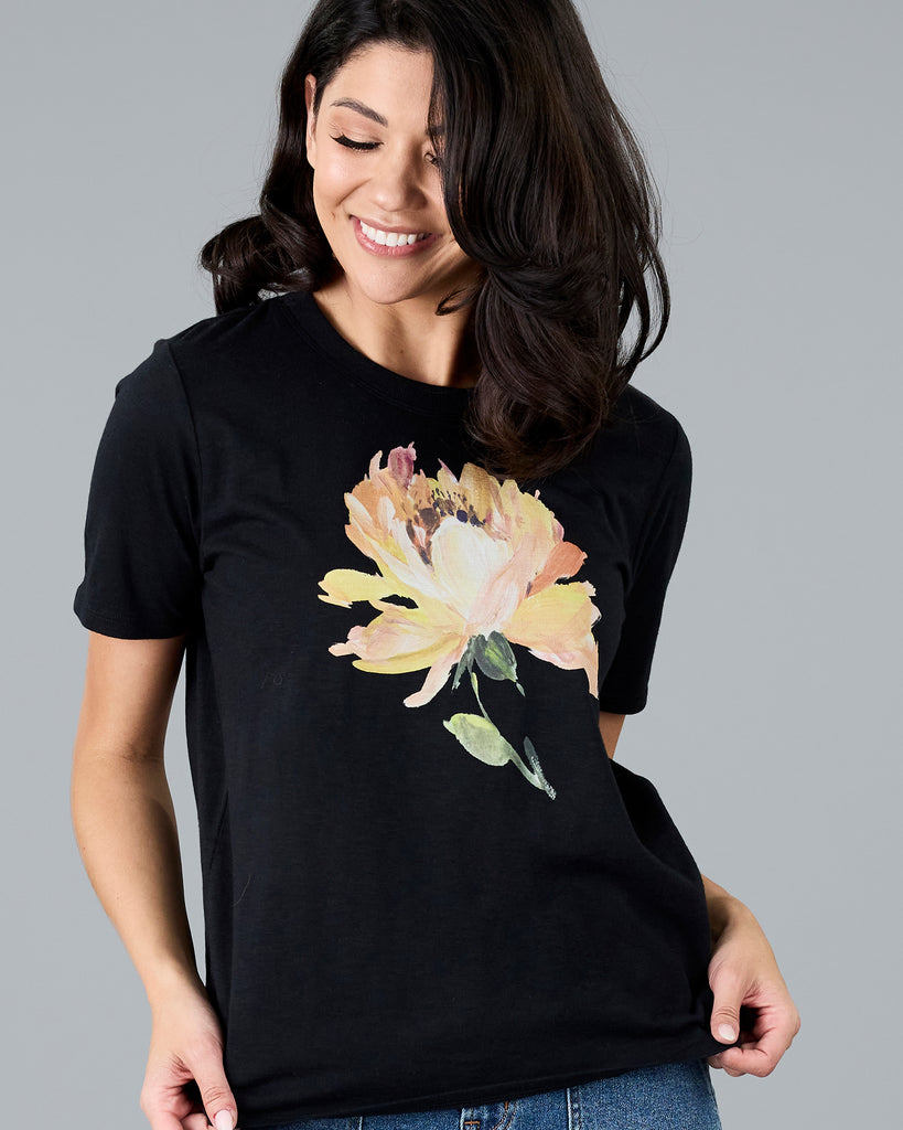 Woman in a black short sleeve tee with floral graphic design