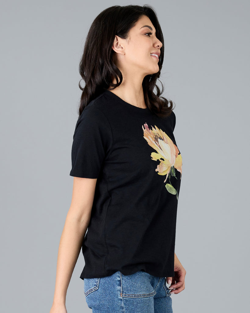 Woman in a black short sleeve tee with floral graphic design