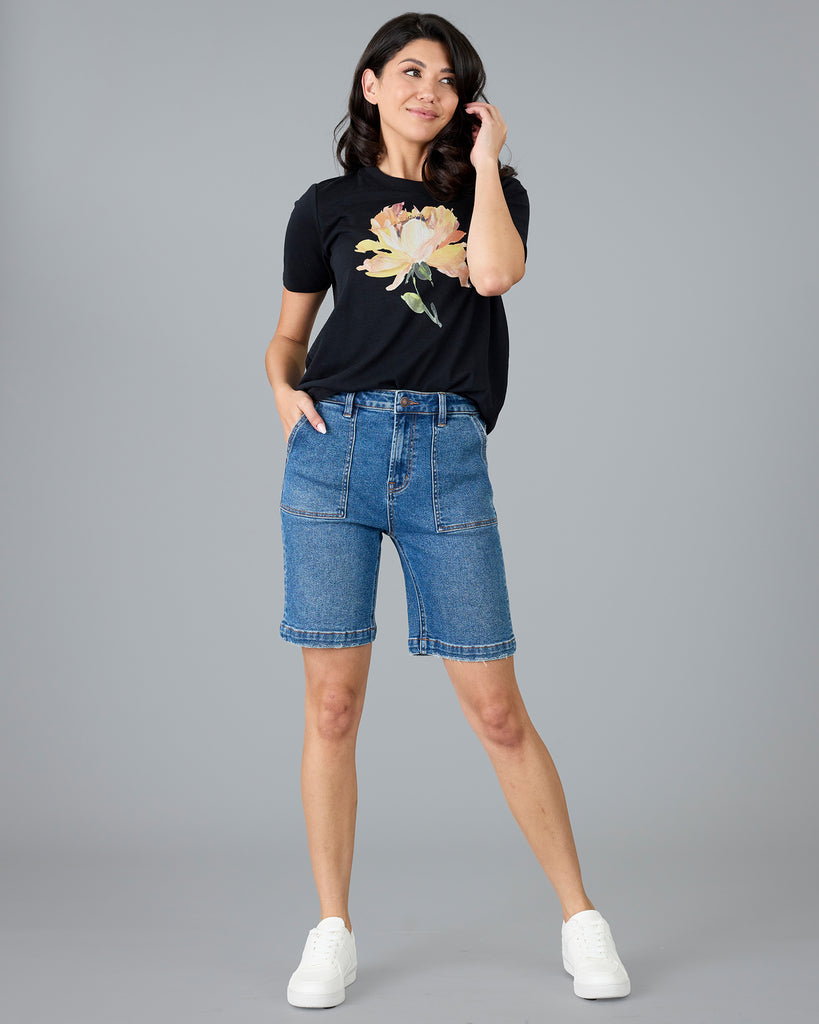 Woman in a black short sleeve tee with floral graphic design