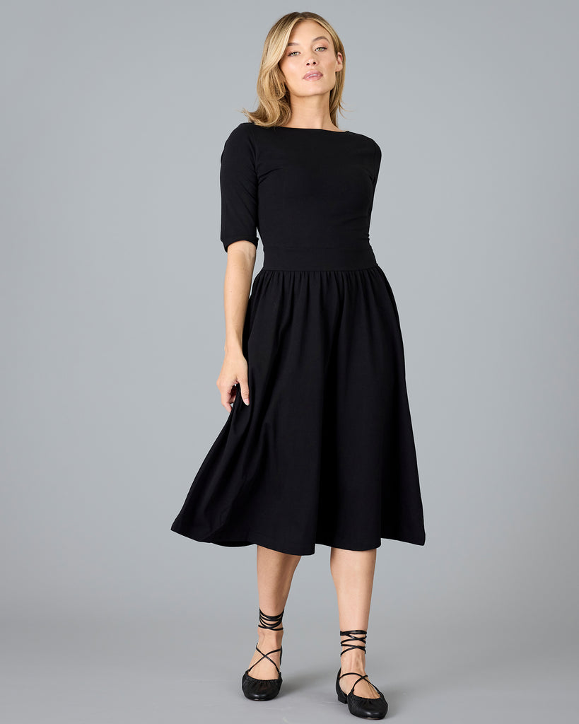 Woman in a black half sleeved a-line dress