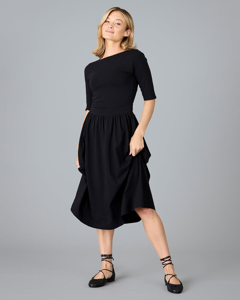 Woman in a black half sleeved a-line dress