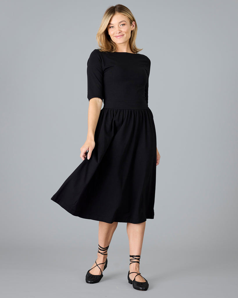 Woman in a black half sleeved a-line dress