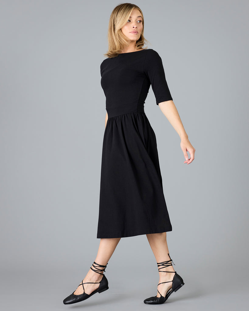 Woman in a black half sleeved a-line dress