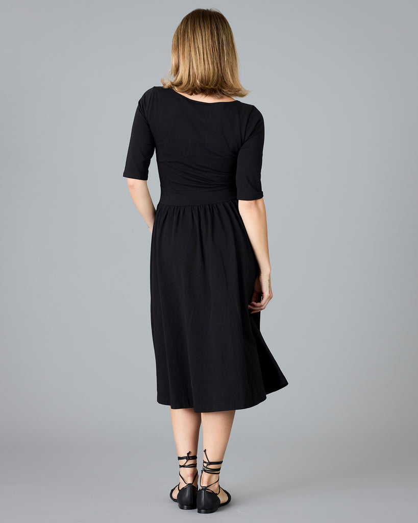 Woman in a black half sleeved a-line dress