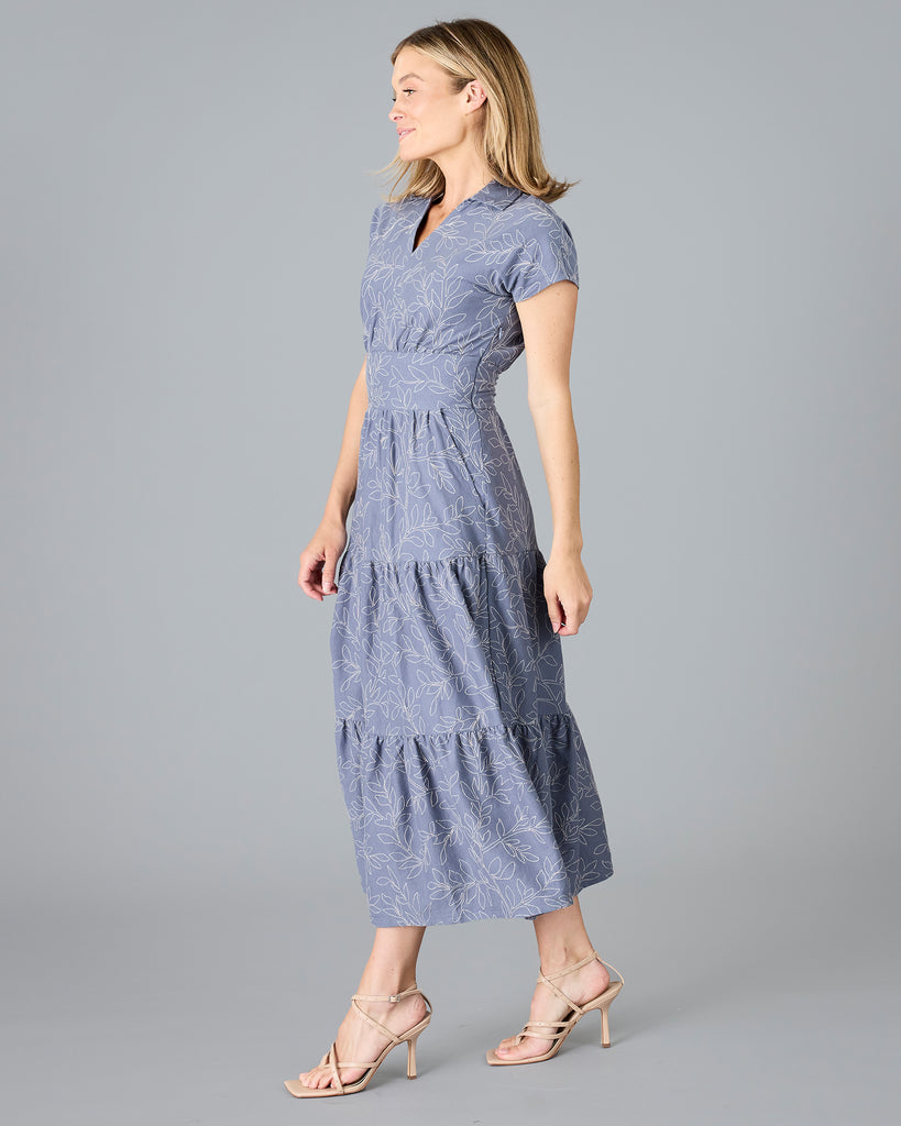 Woman in a blue short sleeve dress